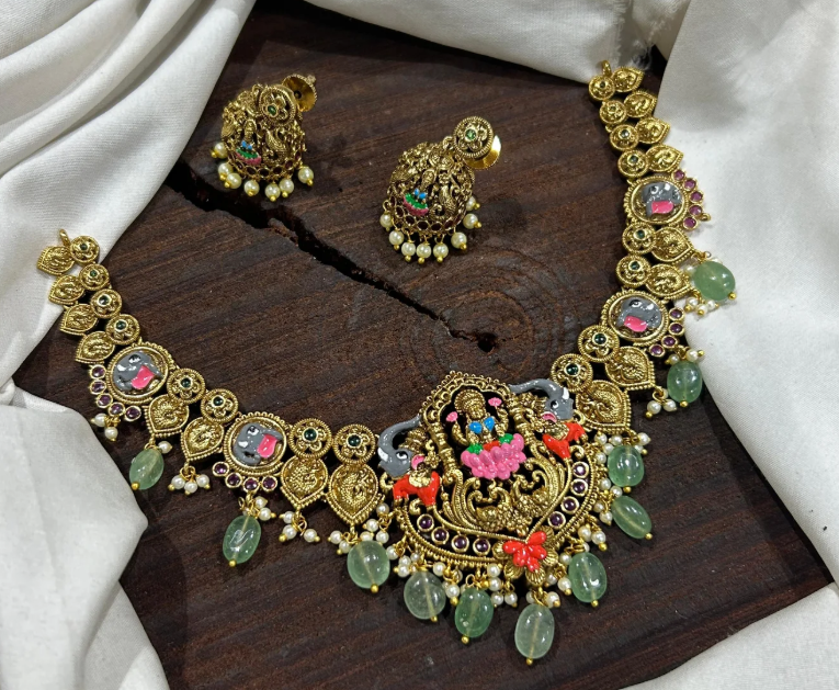 Before - Gold necklace and earring set flat on table